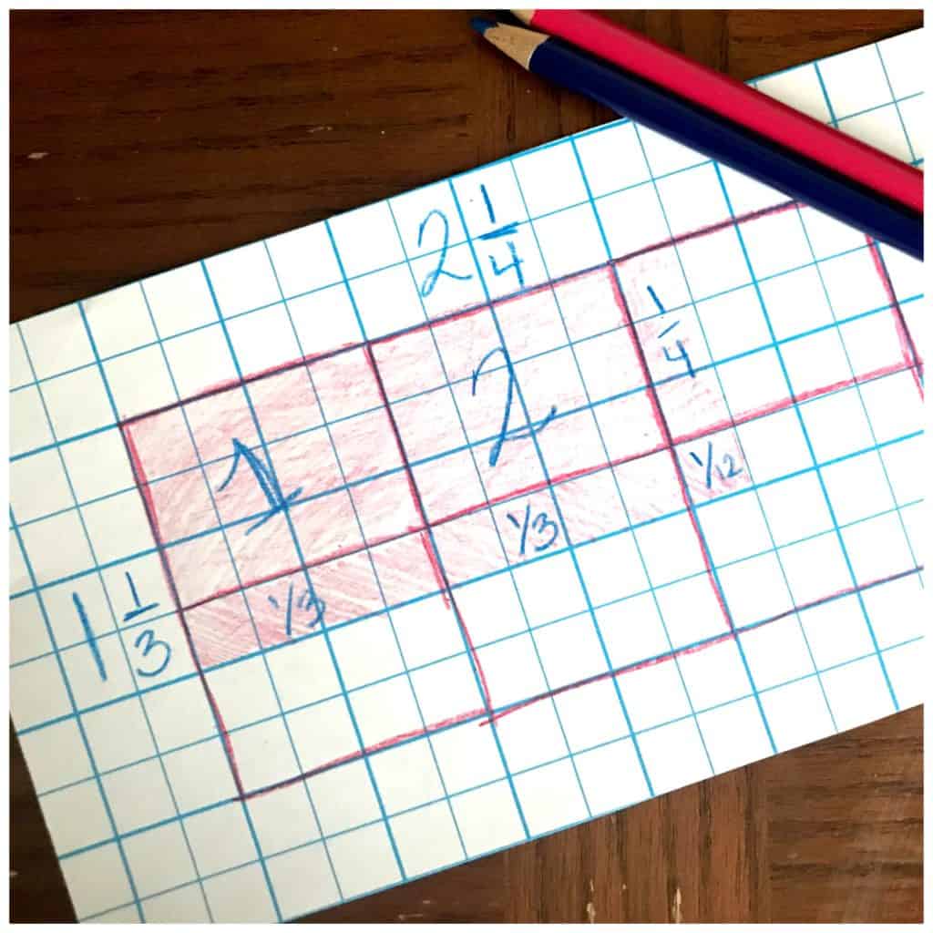 Multiplication arrays game worksheet on a wooden table with two pencils. 
