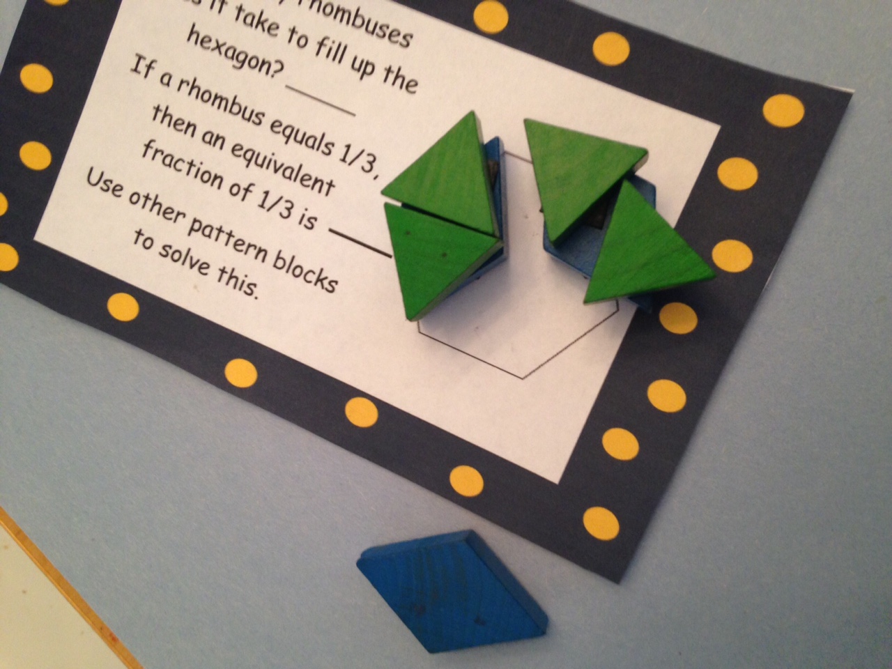 Fractions with pattern blocks task cards on a wooden table.