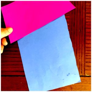 A fraction craft is made with blue and pink construction paper. 