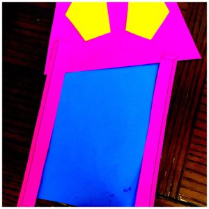 A fraction craft is made with blue and pink construction paper. 