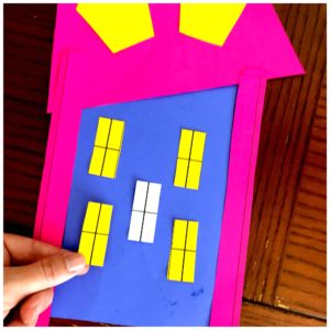 A fraction craft is made with blue and pink construction paper. 