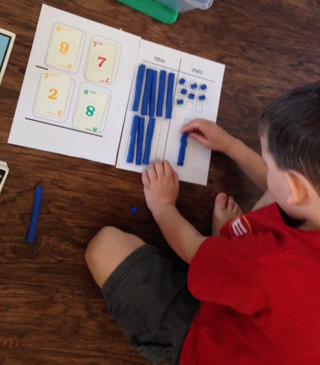 Subtraction with Base Ten Blocks worksheets with playing cards and base ten blocks on a wooden table. 