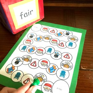 Air phonics game with game pieces on a wooden background. 