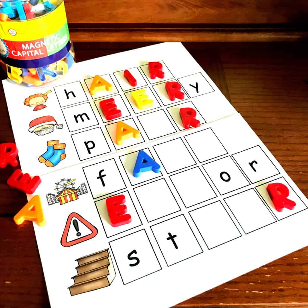 Air phonics game with colorful letters on a wooden background. 
