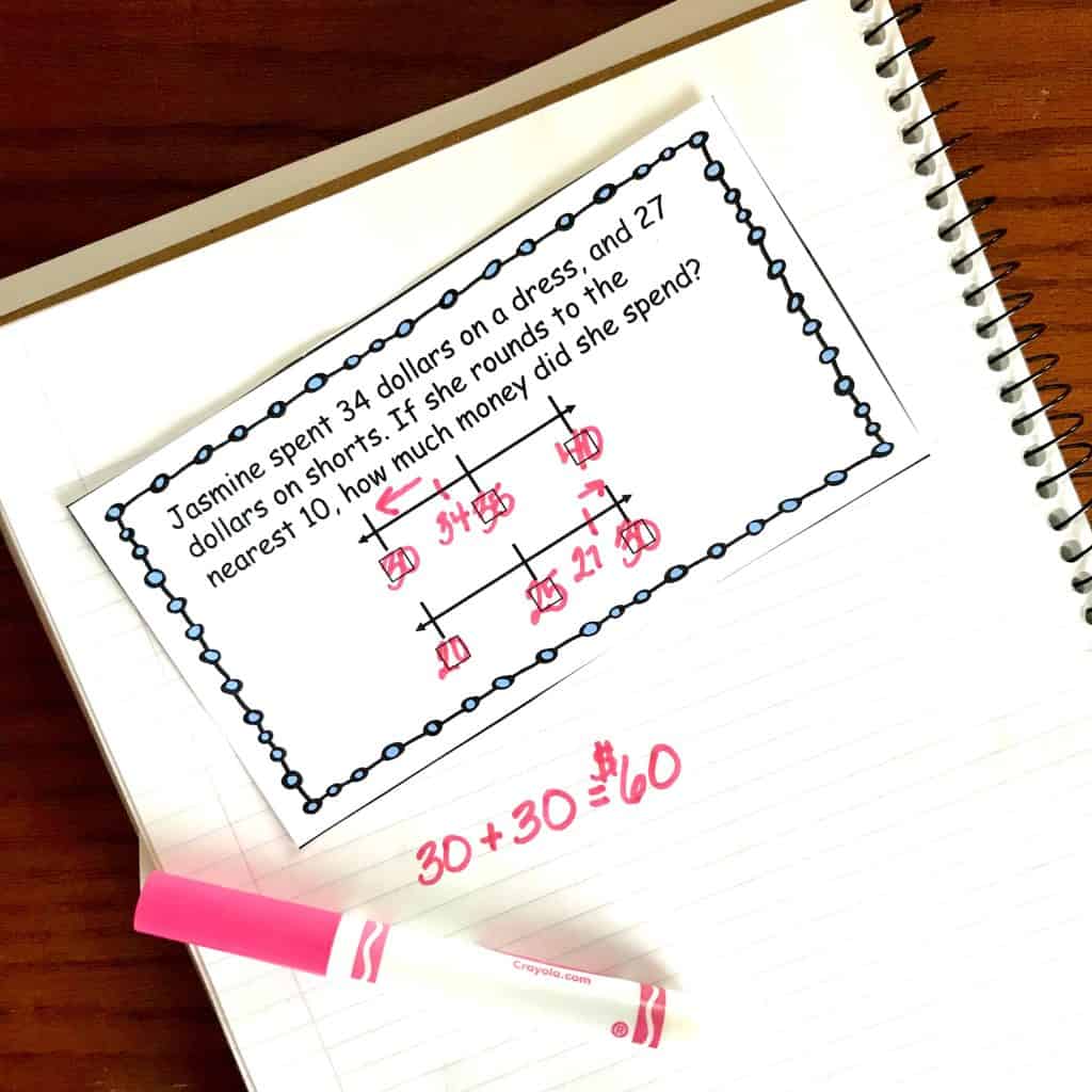 Rounding to nearest tenth word problems filled out with a pink marker. 