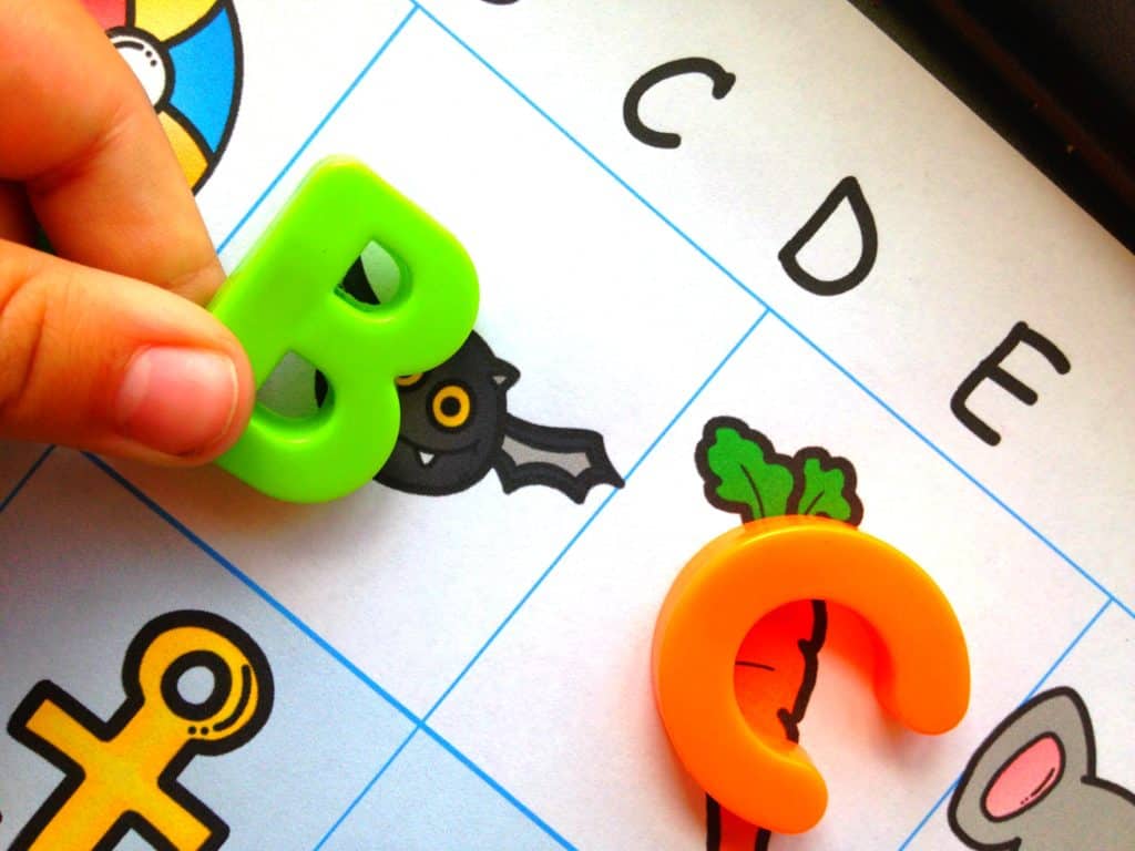 Beginning sounds activities worksheet that is filled with images of various things and magnetic letters. 