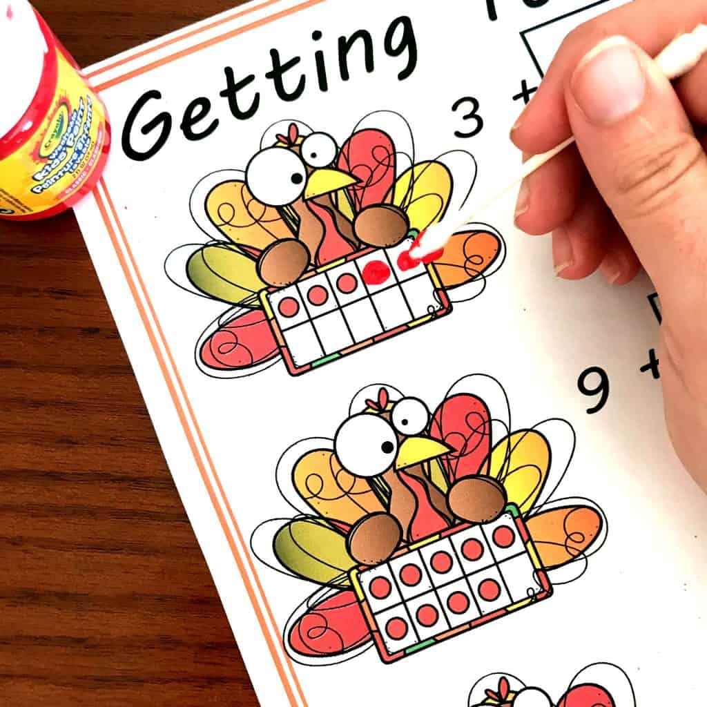 Thanksgiving ten frames printable with a hand filling in the ten frame.
