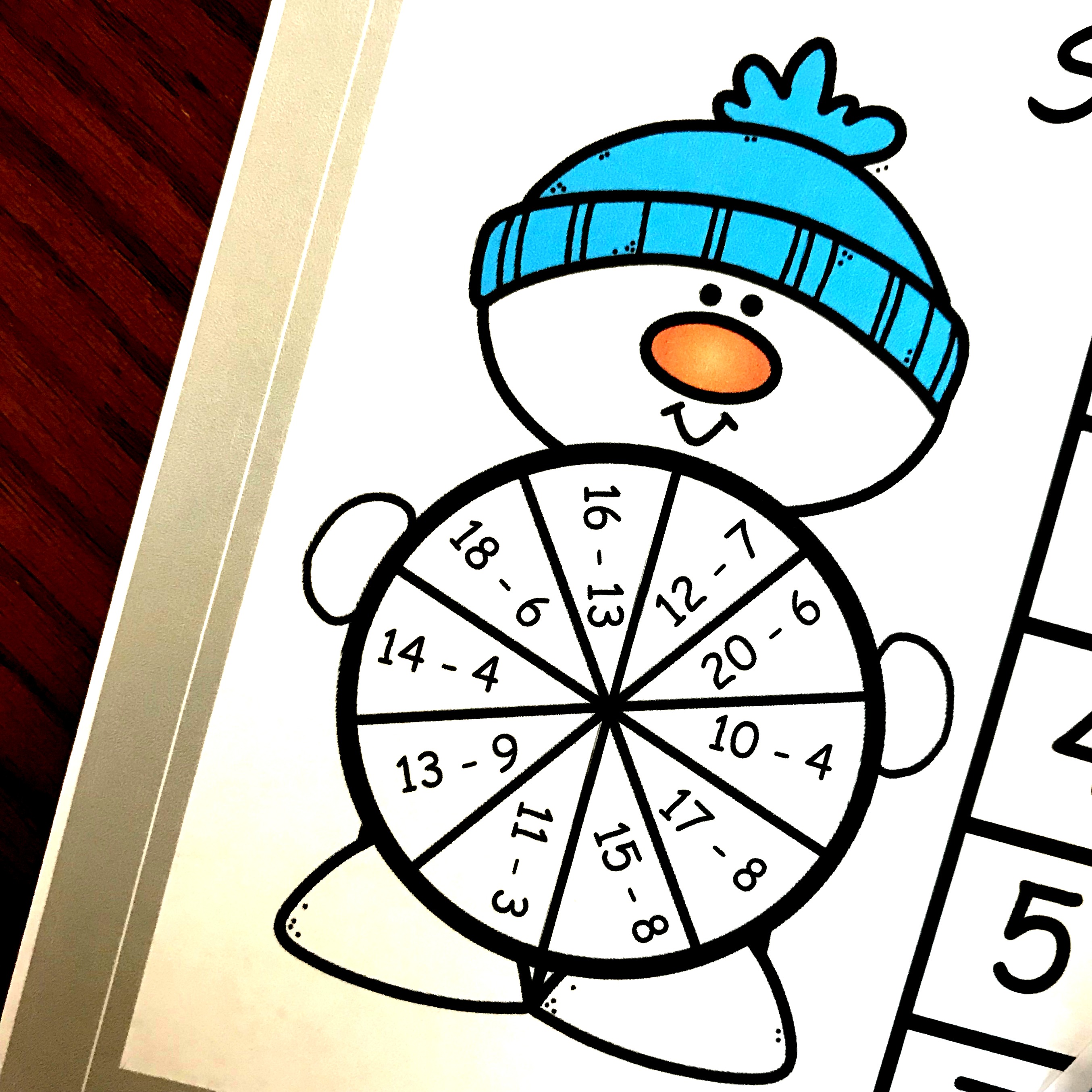 A snowmen subtraction game for kids printable on a table.