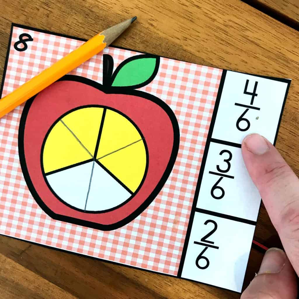 Equivalent Fraction Activity clip card on a wooden background. 
