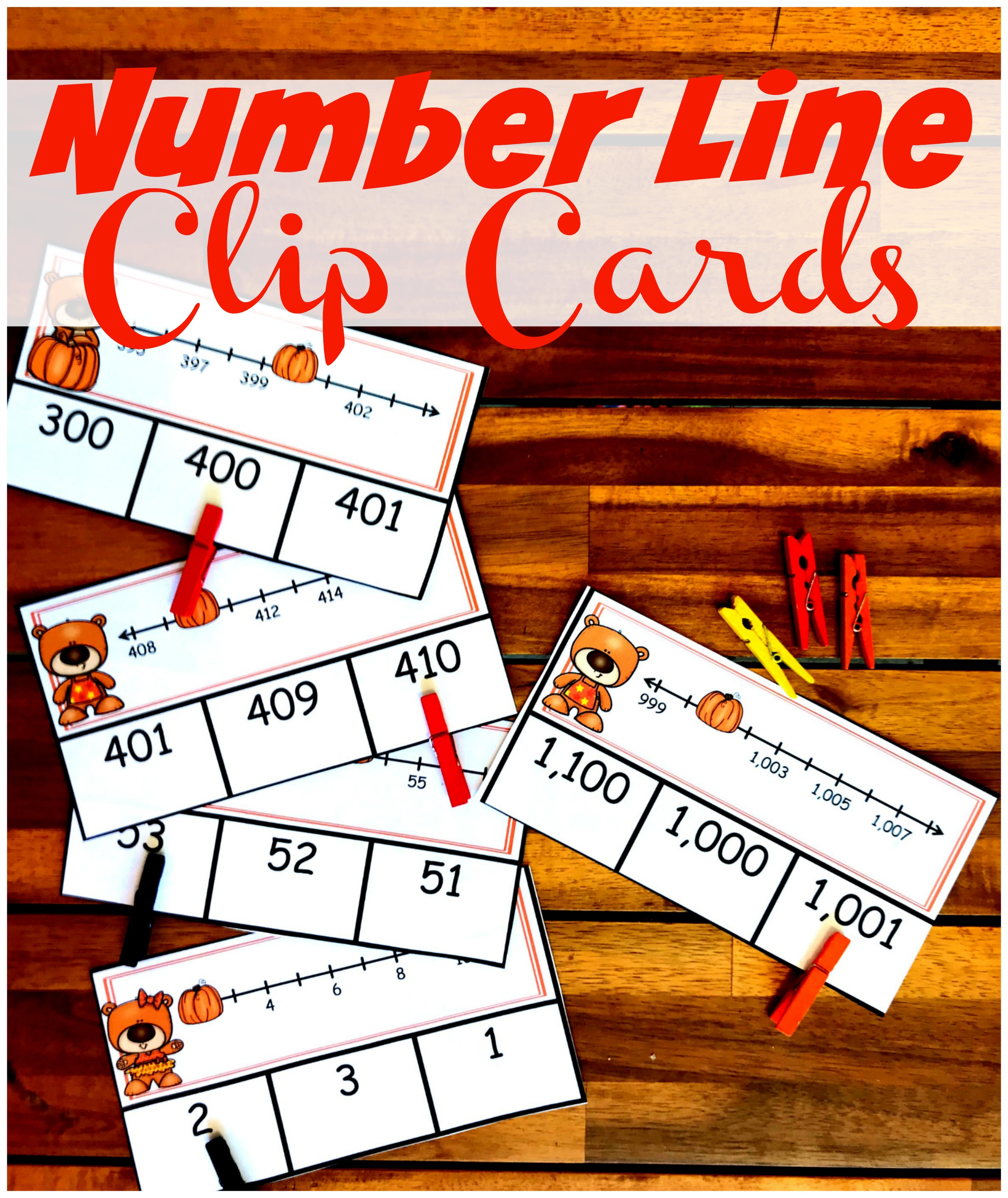 Number line clip cards with clothespins on the answer with a wooden background. 