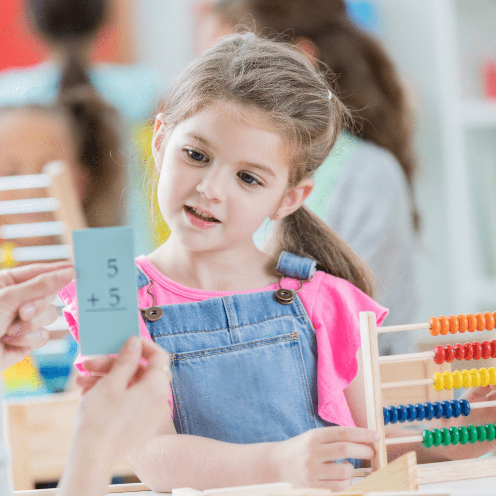 young girl doing basic math